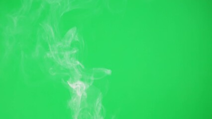 Abstract smoke on green chroma key background. Smoking, steam clouds close-up.