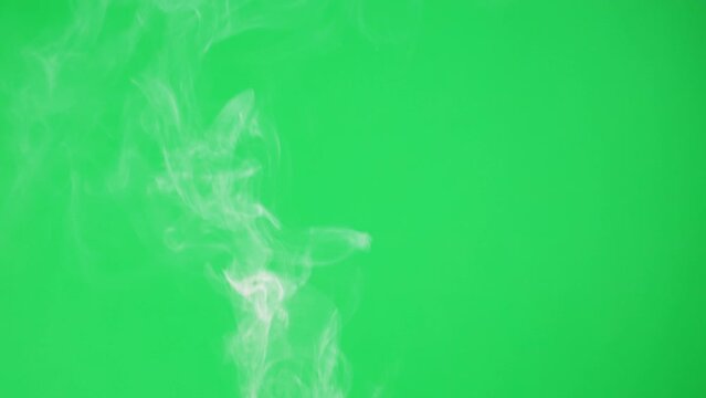 Abstract Smoke On Green Chroma Key Background. Smoking, Steam Clouds Close-up.