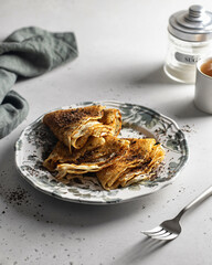 Concept of tasty food with crepes on textured background
