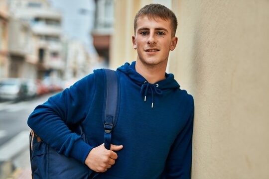 Young blond student smiling happy standing at the university.