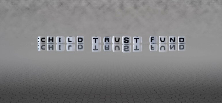 Child Trust Fund Word Or Concept Represented By Black And White Letter Cubes On A Grey Horizon Background Stretching To Infinity