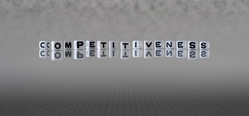competitiveness word or concept represented by black and white letter cubes on a grey horizon...