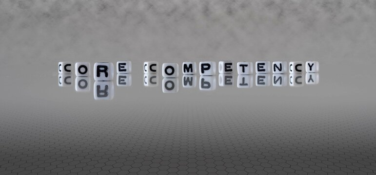 core competency word or concept represented by black and white letter cubes on a grey horizon background stretching to infinity