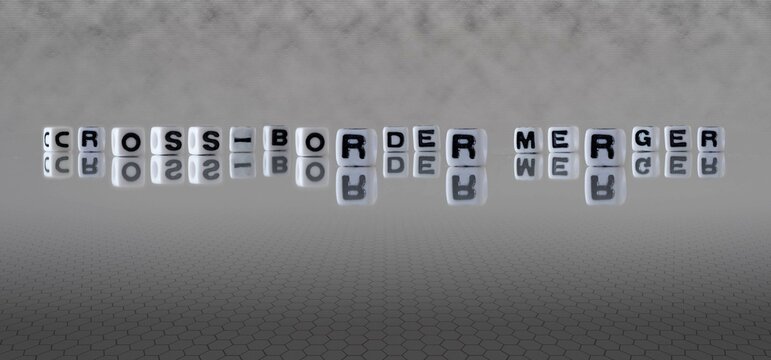 Cross Border Merger Word Or Concept Represented By Black And White Letter Cubes On A Grey Horizon Background Stretching To Infinity