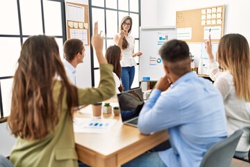Group of business workers on chart board presentation at the office.