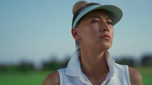 Golf player enjoy country club at green course. Woman golfer looking sunlight.