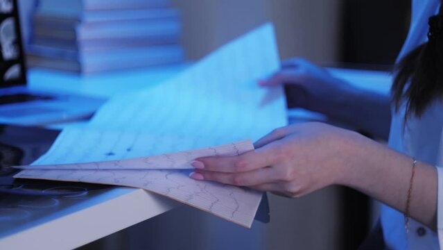 Man wearing EEG topographer for examining brain, doctor making electrogram of scalp activity. Researching of brain work using electroencephalography headset.