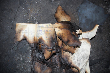 Old burnt paper with handwritten text 