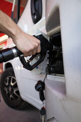 Caucasian man hand filling the fuel tank in a mobile home with fuel to start a long travel