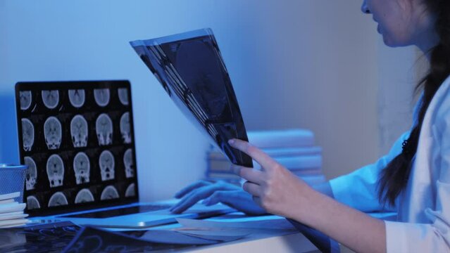Man wearing EEG topographer for examining brain, doctor making electrogram of scalp activity. Researching of brain work using electroencephalography headset.