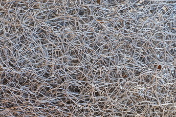 Metal wire texture background in full screen. Scrap of non-ferrous metals. Recycling concept