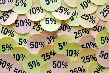 Large amount of stickers with yellow percentage values for black friday or cyber monday sale. Abstract image of discount prices