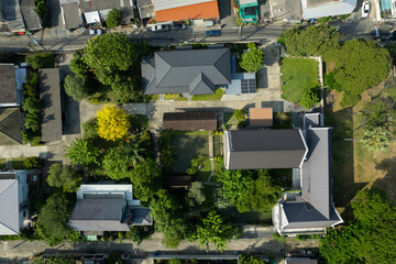 Aerial view of the roof of a house with a car taken by a drone, top view of road