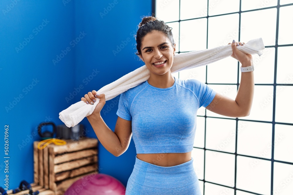 Wall mural young latin woman wearing sportswear standing at sport center - Wall murals