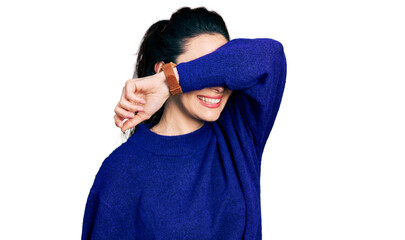 Young hispanic woman wearing casual clothes covering eyes with arm smiling cheerful and funny. blind concept.