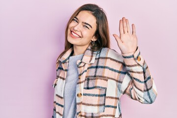 Young caucasian girl wearing casual clothes waiving saying hello happy and smiling, friendly welcome gesture