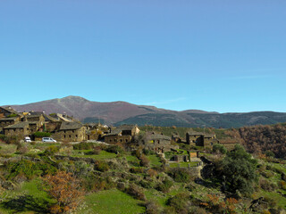 Fototapeta na wymiar Landscape of the Sierra Norte de Guadalajara, Spain, with a view of the town of black architecture called Roblelacasa