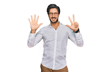 Young hispanic man wearing business shirt and glasses showing and pointing up with fingers number eight while smiling confident and happy.