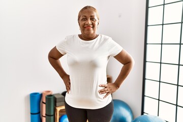 Fototapeta na wymiar Senior african american woman smiling confident standing at sport center