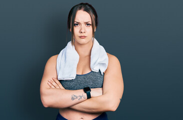 Obraz premium Young hispanic girl wearing sportswear and towel skeptic and nervous, disapproving expression on face with crossed arms. negative person.