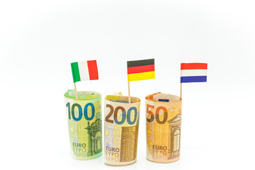 Money and flags of European countries.Flags of Germany, France and Italy euro bills on a white background.euro money inflation.Inflation and economic recession in Europe. 