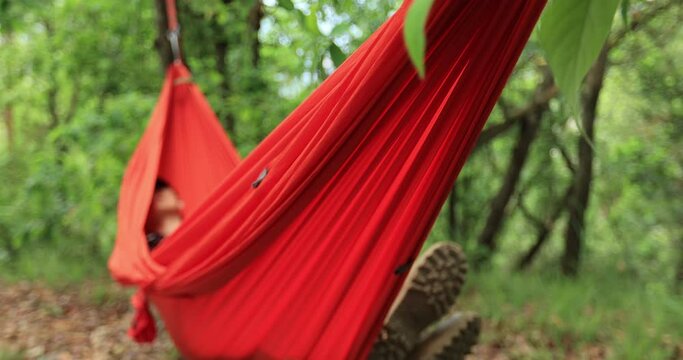 Relaxing in hammock in tropical forest
