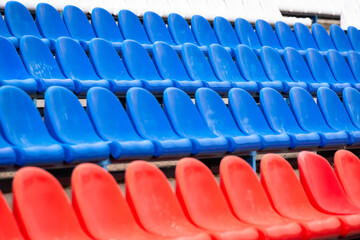 Benches (seats for spectators) are plastic in the stadium, tricolor, blue, red and white.