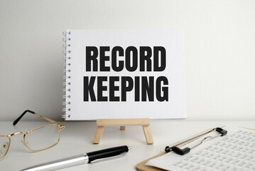 Word text RECORD KEEPING on white paper card business concept