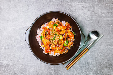 Nakjideopbap, Korean style spicy stir-fried octopus over rice : This dish is made by stir-frying sliced onion and carrots along with sauce over high heat in an oiled pan. Bite-sized pieces of octopus 