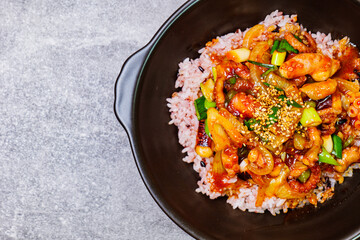 Nakjideopbap, Korean style spicy stir-fried octopus over rice : This dish is made by stir-frying sliced onion and carrots along with sauce over high heat in an oiled pan. Bite-sized pieces of octopus 
