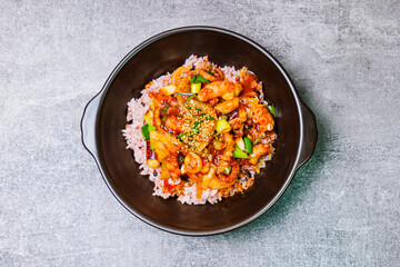 Nakjideopbap, Korean style spicy stir-fried octopus over rice : This dish is made by stir-frying sliced onion and carrots along with sauce over high heat in an oiled pan. Bite-sized pieces of octopus 