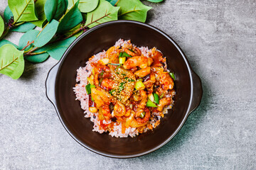 Nakjideopbap, Korean style spicy stir-fried octopus over rice : This dish is made by stir-frying sliced onion and carrots along with sauce over high heat in an oiled pan. Bite-sized pieces of octopus 
