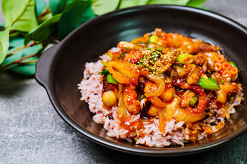 Nakjideopbap, Korean style spicy stir-fried octopus over rice : This dish is made by stir-frying sliced onion and carrots along with sauce over high heat in an oiled pan. Bite-sized pieces of octopus 