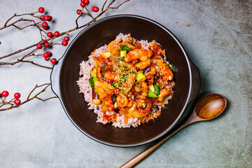 Nakjideopbap, Korean style spicy stir-fried octopus over rice : This dish is made by stir-frying sliced onion and carrots along with sauce over high heat in an oiled pan. Bite-sized pieces of octopus 