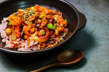 Nakjideopbap, Korean style spicy stir-fried octopus over rice : This dish is made by stir-frying sliced onion and carrots along with sauce over high heat in an oiled pan. Bite-sized pieces of octopus 