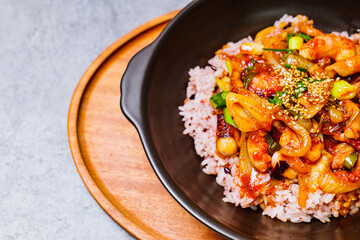 Nakjideopbap, Korean style spicy stir-fried octopus over rice : This dish is made by stir-frying sliced onion and carrots along with sauce over high heat in an oiled pan. Bite-sized pieces of octopus 