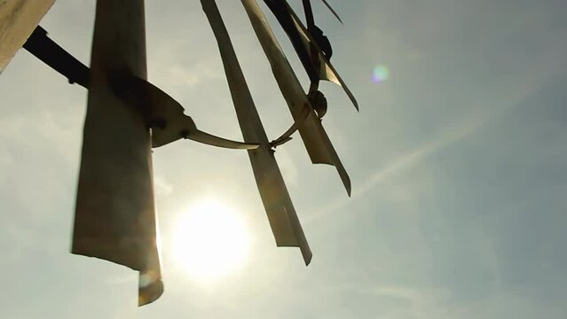 Sun Shining behind an Old Windmill at a Rural Field in Argentina. Close Up. Elevated View. 4K Resolution.
