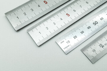 Iron ruler close-up on a white background. Stainless steel ruler. Working tools made of metal and...