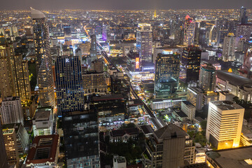 Fototapeta na wymiar Aerial view of Ploenchit junction with cars traffic skyscraper buildings. Bangkok City in downtown at night, Thailand