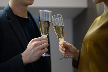 Man and woman toasting, close-up of hands