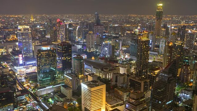 Aerial view of Ploenchit junction with cars traffic skyscraper buildings. Bangkok City in downtown at night, Thailand
