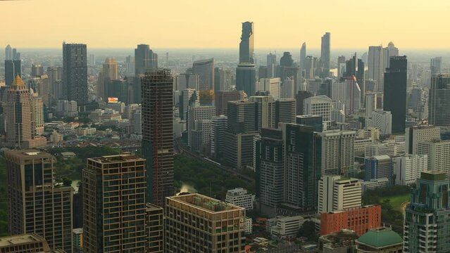 Aerial view of Ploenchit junction with cars traffic skyscraper buildings. Bangkok City in downtown at night, Thailand

