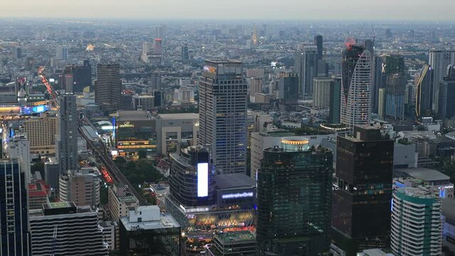 Aerial view of Ploenchit junction with cars traffic skyscraper buildings. Bangkok City in downtown at night, Thailand
