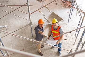 Construction concept of Engineer and Architect working at Construction Site with blue print