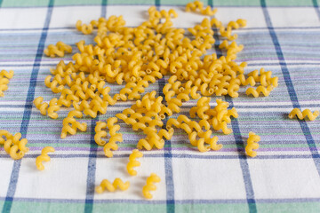 Pasta of different shapes from durum wheat varieties on a kitchen towel close-up. Proper nutrition. Food and cuisine