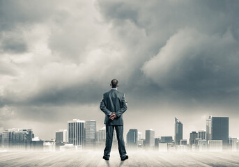 Motivation and inspiration concept with modern cityscape and businessman observing it