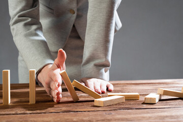 Business woman hand block domino effect