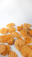 Homemade potato chips on a white background