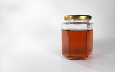 Natural honey in a bottle on a white background, perfect for mockup needs or graphic design templates