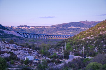 Viaduct across the valley with series of arches carrying a road
